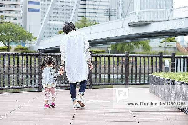 Japanese mother and daughter at a city park