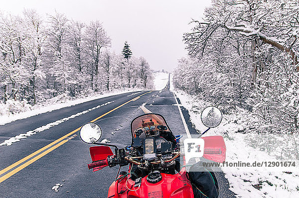 Touring motorcycle parked on roadside in winter  Placerville  California  USA