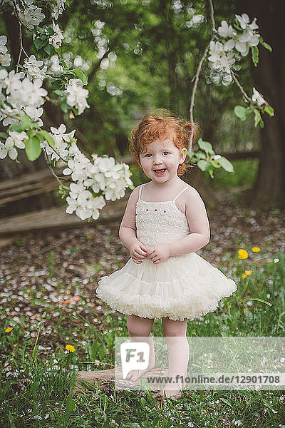Toddler in tutu by blossom tree