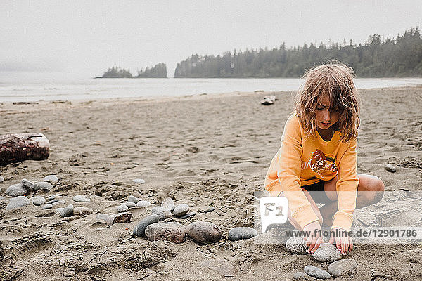 Girl playing on beach  Tofino  Canada