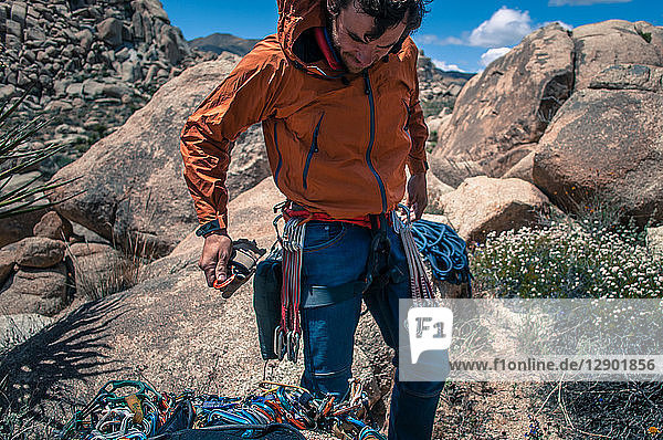 Rock climber wearing safety gear  Joshua Tree  California  USA