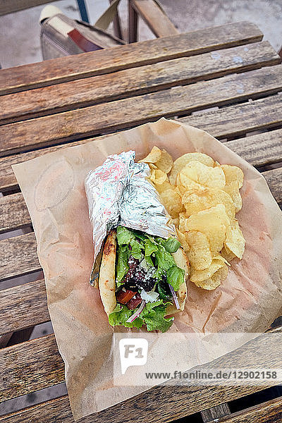 Meal of salad wrap and potato chips