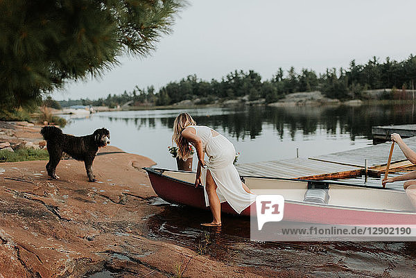 Couple and pet dog getting off boat  Algonquin Park  Canada