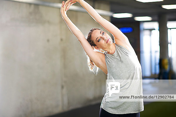 Woman doing stretching exercise in gym