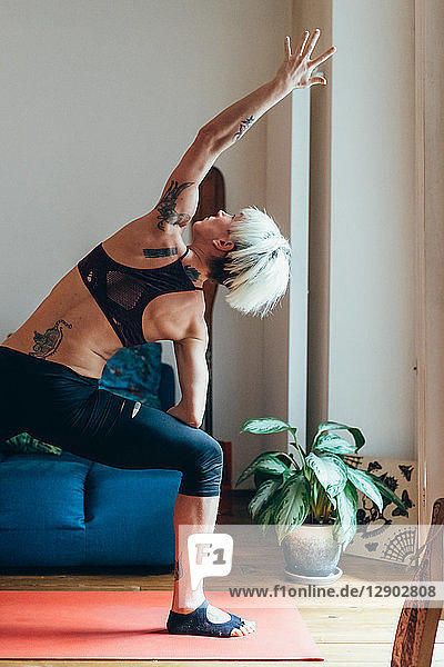 Woman practising yoga at home