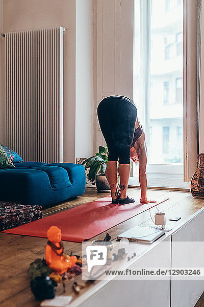 Woman practising yoga at home