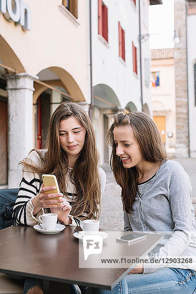 Freundinnen mit Mobiltelefon im Café  Belluno  Venetien  Italien