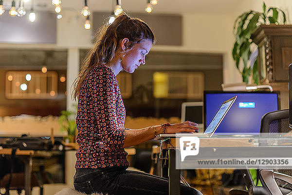 Young woman working late in office