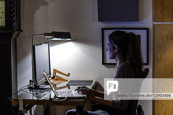Young woman working late in office