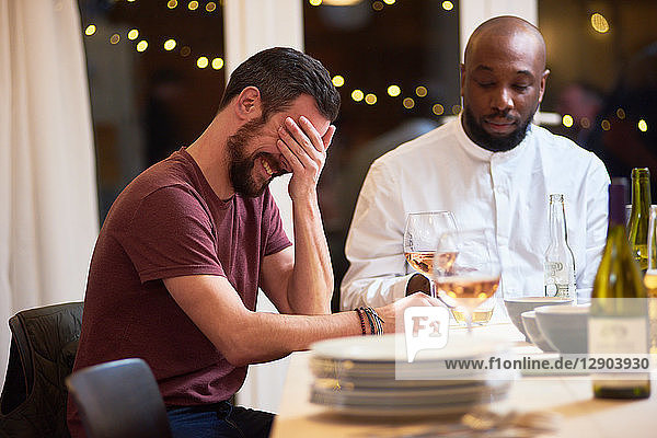 Friend laughing at dinner party