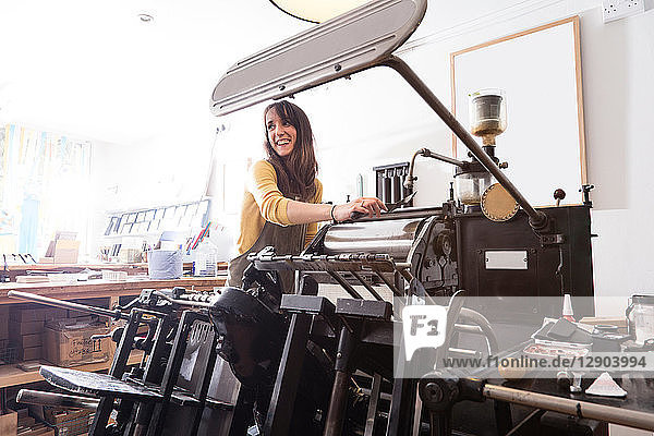 Woman preparing printer in shop