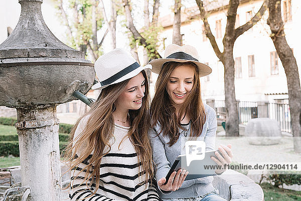 Freundinnen mit digitalem Tablet auf der Piazza  Belluno  Venetien  Italien