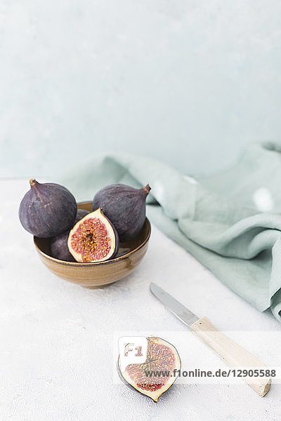 Sliced and whole fresh figs  kitchen knife and cloth