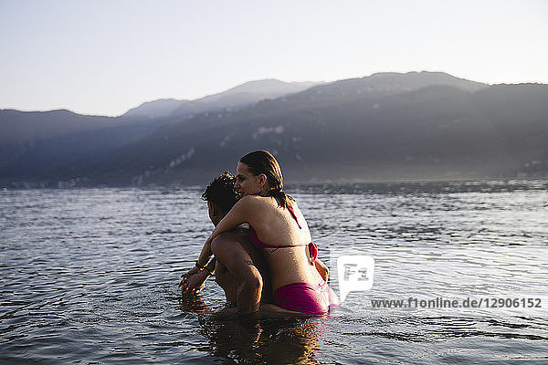 Happy affectionate young couple in a lake