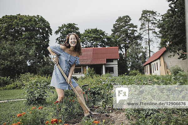 Portrait of happy woman working in garden