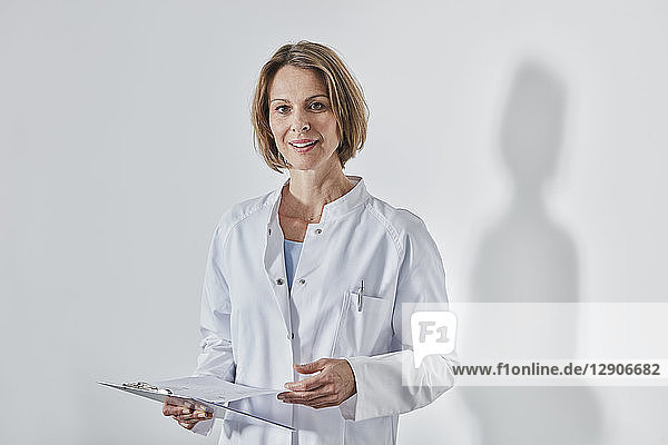 Portrait of female doctor with anamnesis questionnaire