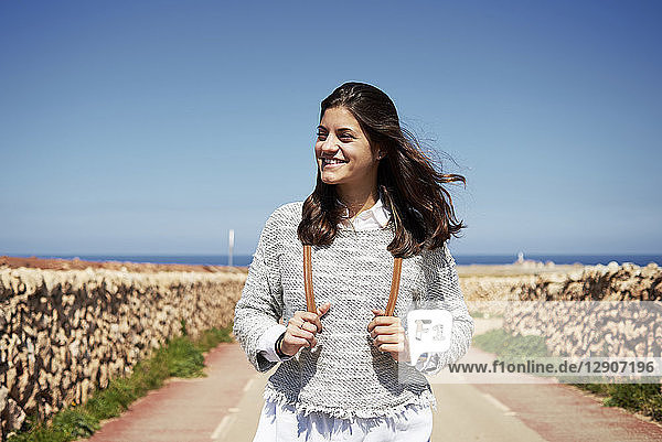 Young smiling brunette woman outdoors