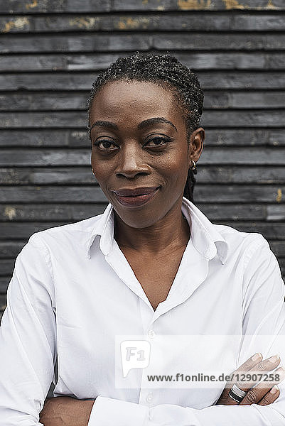 Portrait of smiling businesswoman wearing white shirt