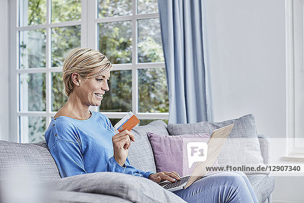 Happy woman at home shopping online