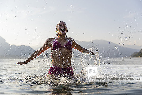 Happy young woman in a lake
