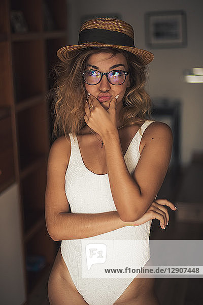 Portrait of young woman wearing a swimsuit and glasses  indoor