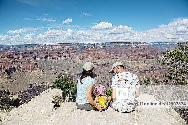 USA  Arizona  Grand Canyon National Park  South Rim  Family sitting on viewpoint