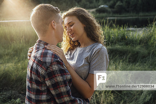 Romantic couple spending time in nature  kissing at sunset