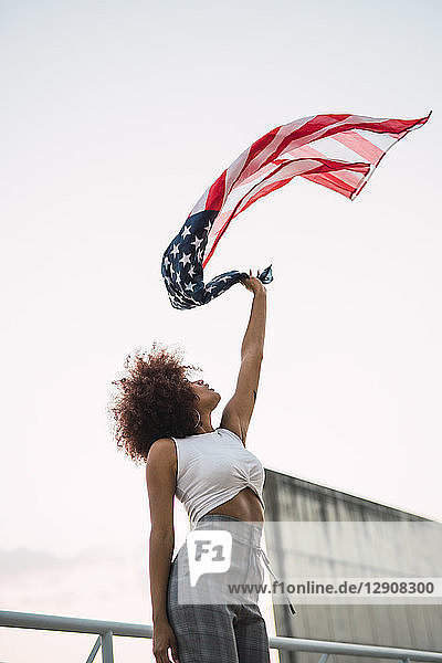 Young woman swinging American flag