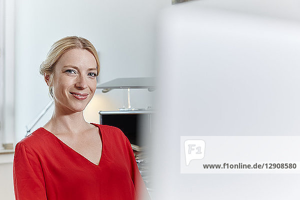 Portrait of smiling young woman in office