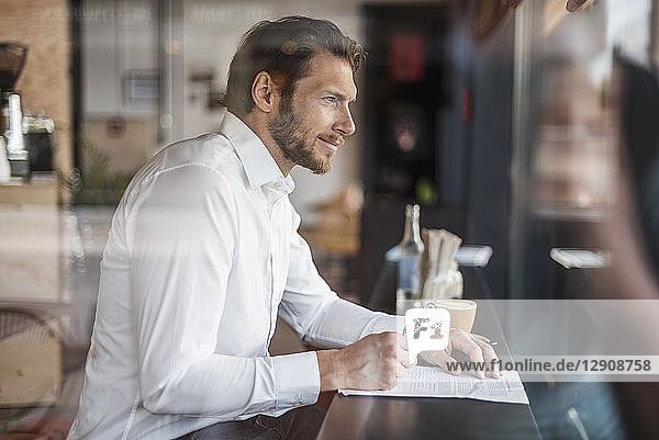 Businessman in a cafe taking notes