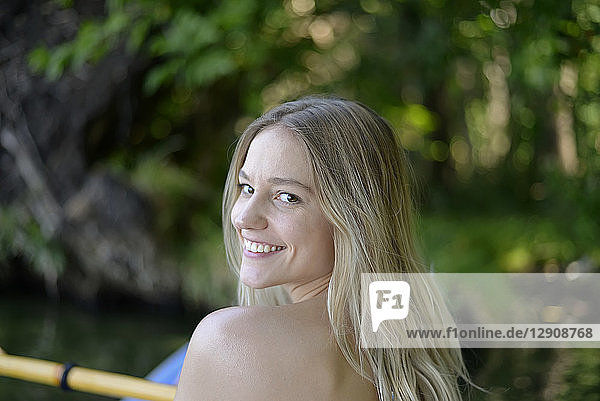 Portrait of smiling blond woman kayaking