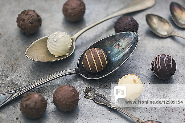 Various chocolate truffles and old spoons