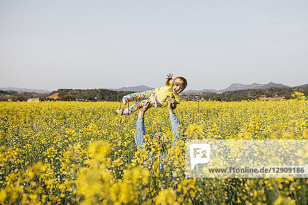 Spain  father and baby girl having fun together in a rape field