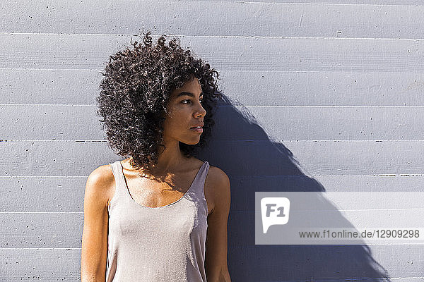 Young woman with curly hair waiting