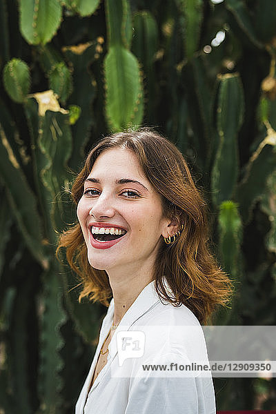 Portrait of a young woman in front of cacti