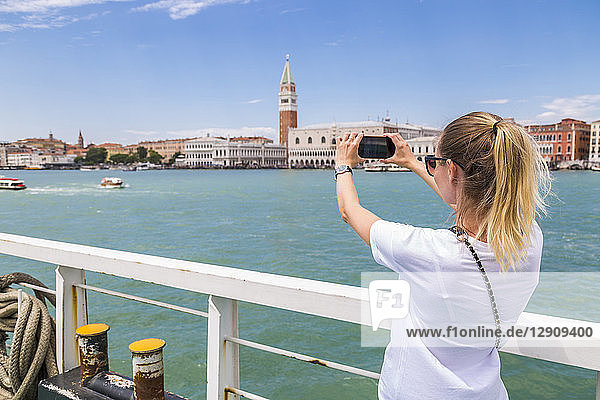 Italy  Venice  tourist taking a smartphone picture from the city