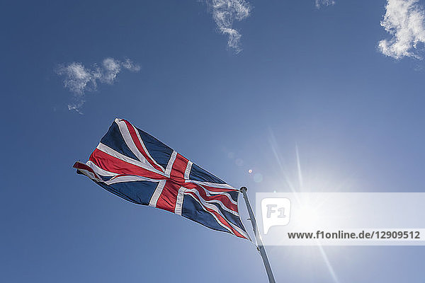 Union Jack in blue sky with backlight
