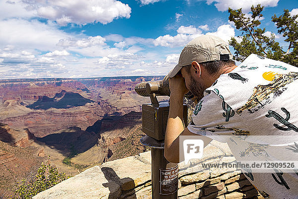 USA  Arizona  Grand Canyon National Park  Grand Canyon  man looking through telescope