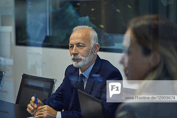 Portrait of senior businessman listening in a meeting