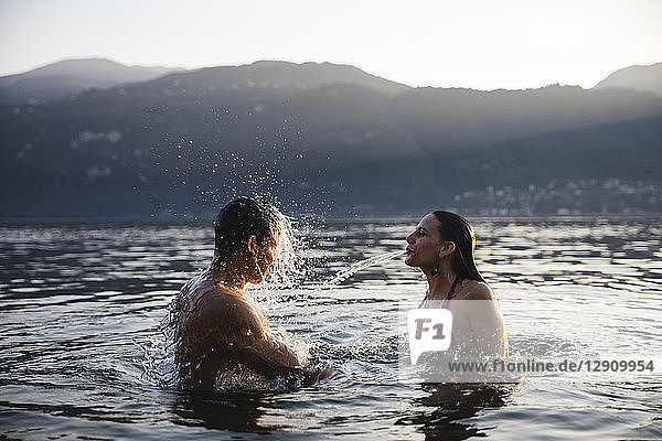 Young couple having fun in a lake
