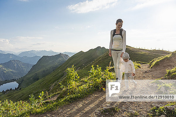 Germany  Bavaria  Oberstdorf  mother and little daughter on a hiking trip in the mountains