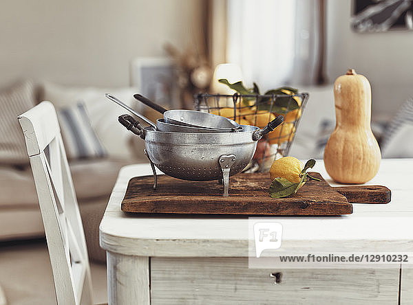 Nostalgic kitchen utensils and fruits on old wooden table