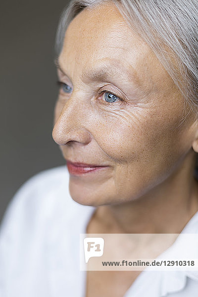 Half profile of blue eyed senior woman