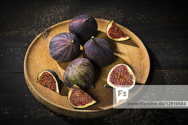 Figs on wooden plate  dark wood