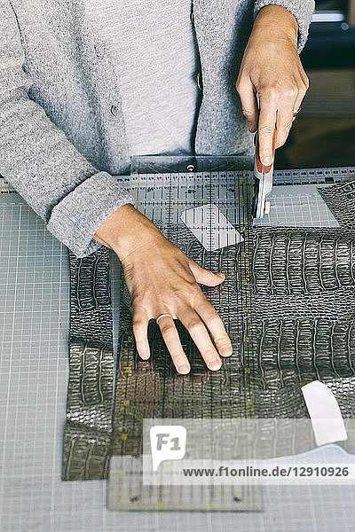 Close-up of fashion designer working on template