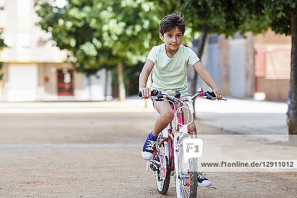 Portrait of little girl riding bicycle
