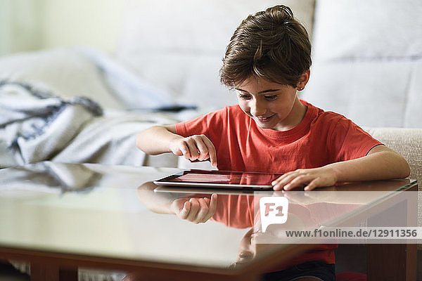 Little girl using digital tablet at home