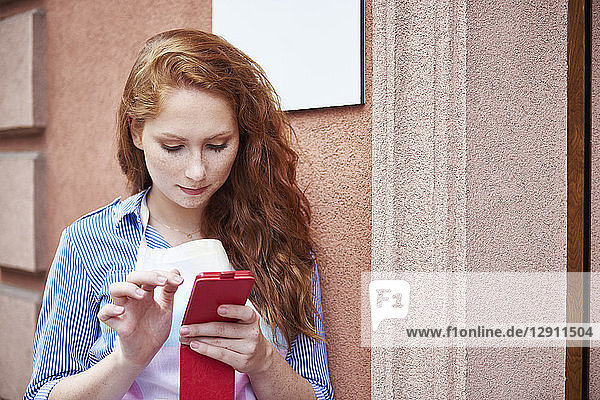 Young woman using a cell phone during a work break