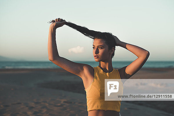 Portrait of teenage girl on the beach at sunset