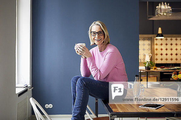 Portait of confident mature woman at home